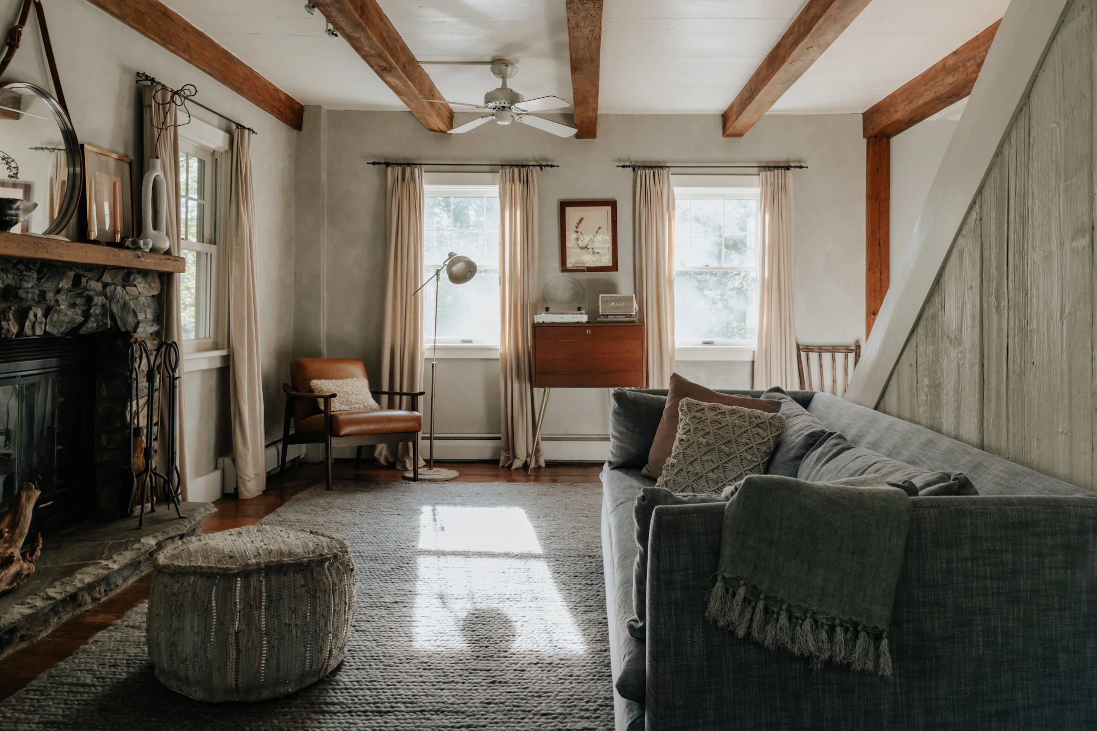 Neutral living room with armchairs, coffee table, soft textiles and home décor