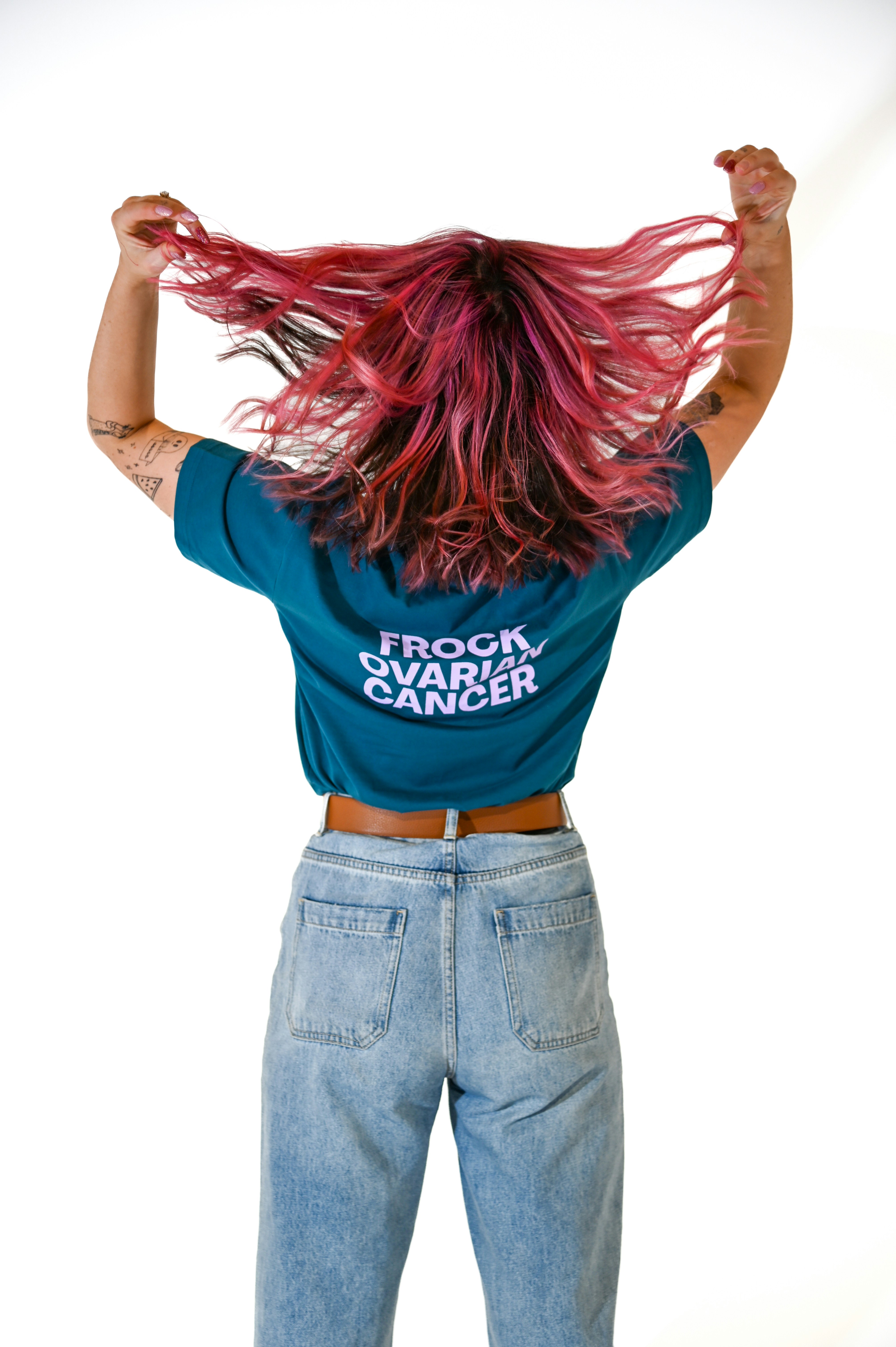 A woman with red hair standing in front of a white background