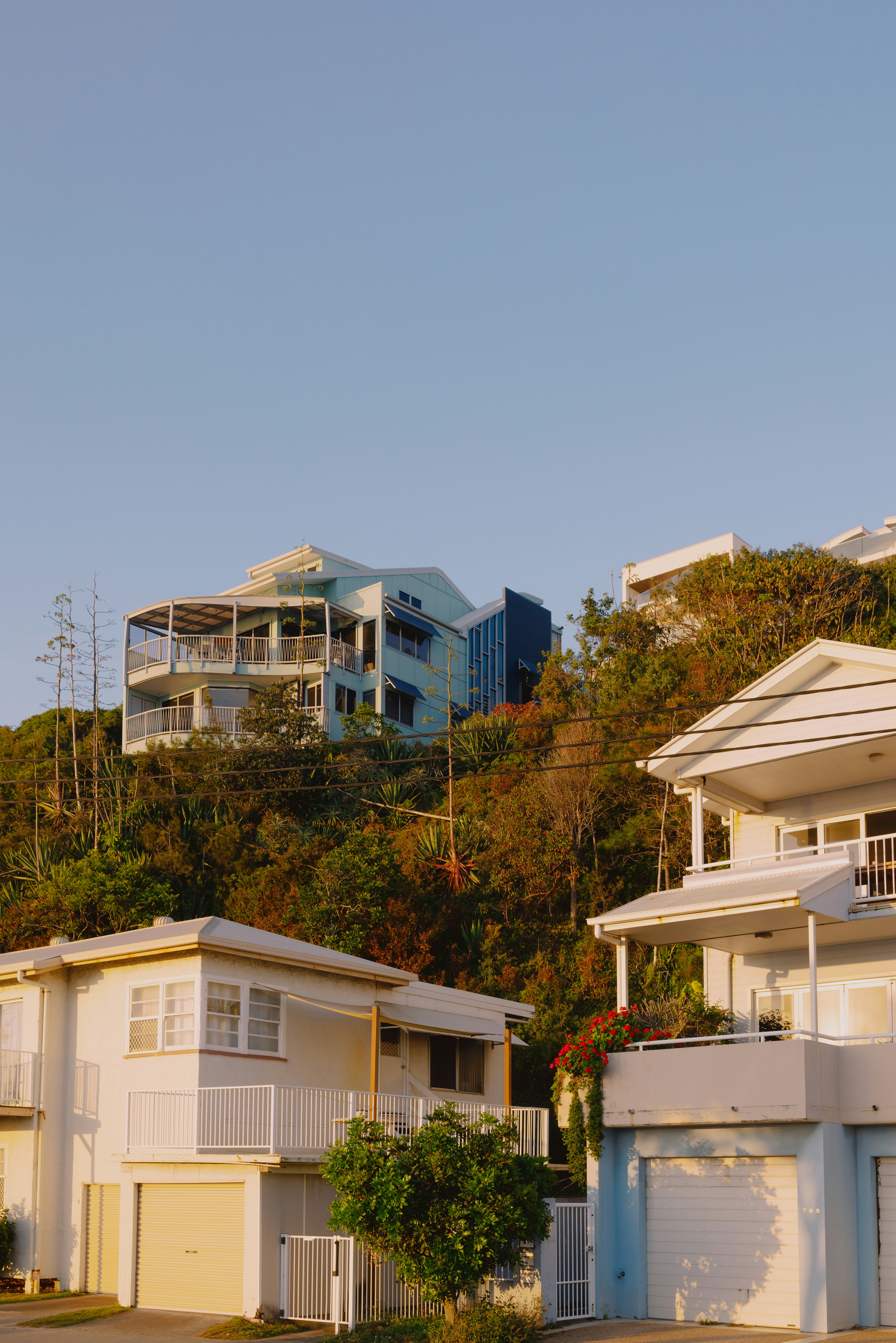 A row of houses sitting on top of a lush green hillside