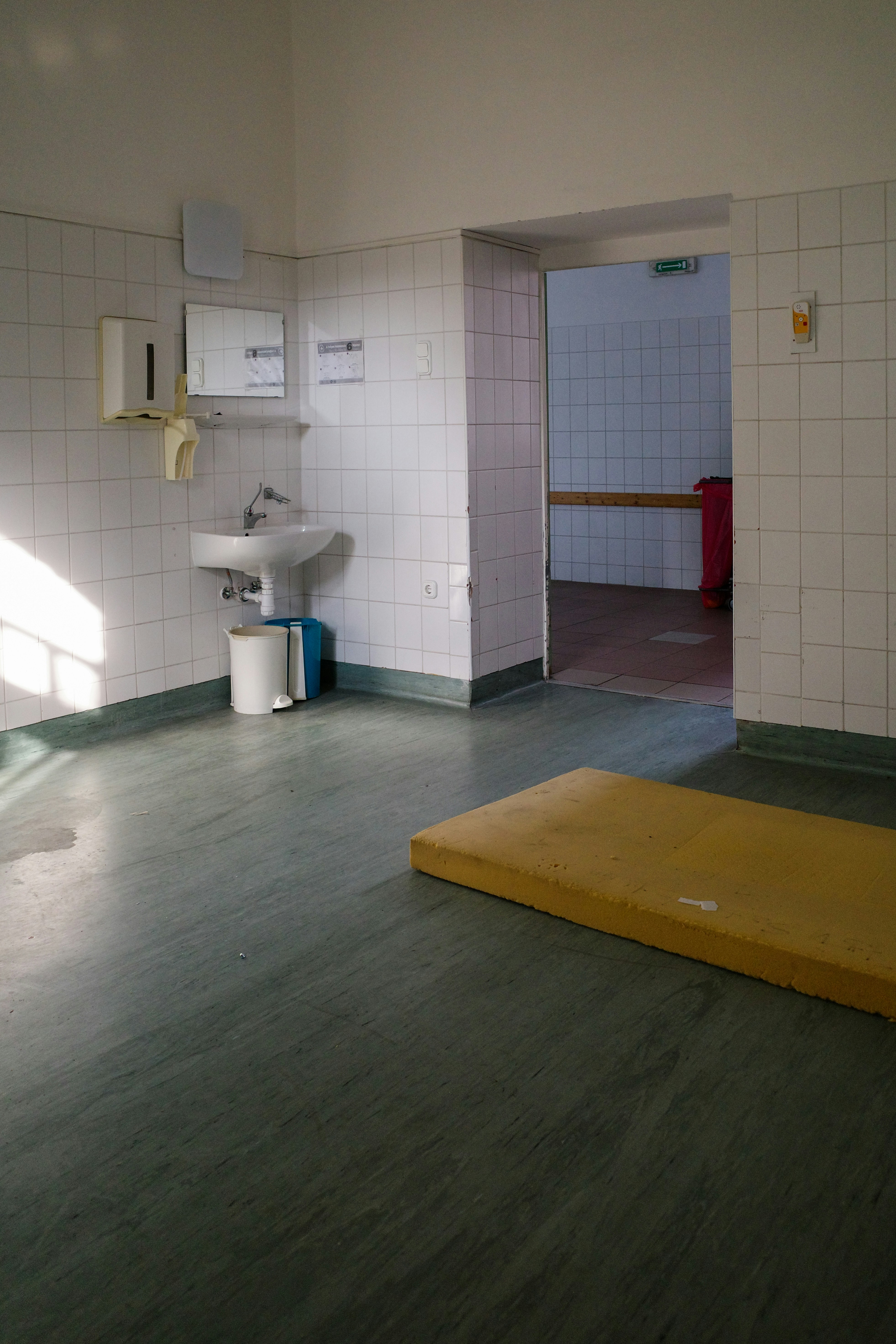 A bathroom with a yellow mat on the floor
