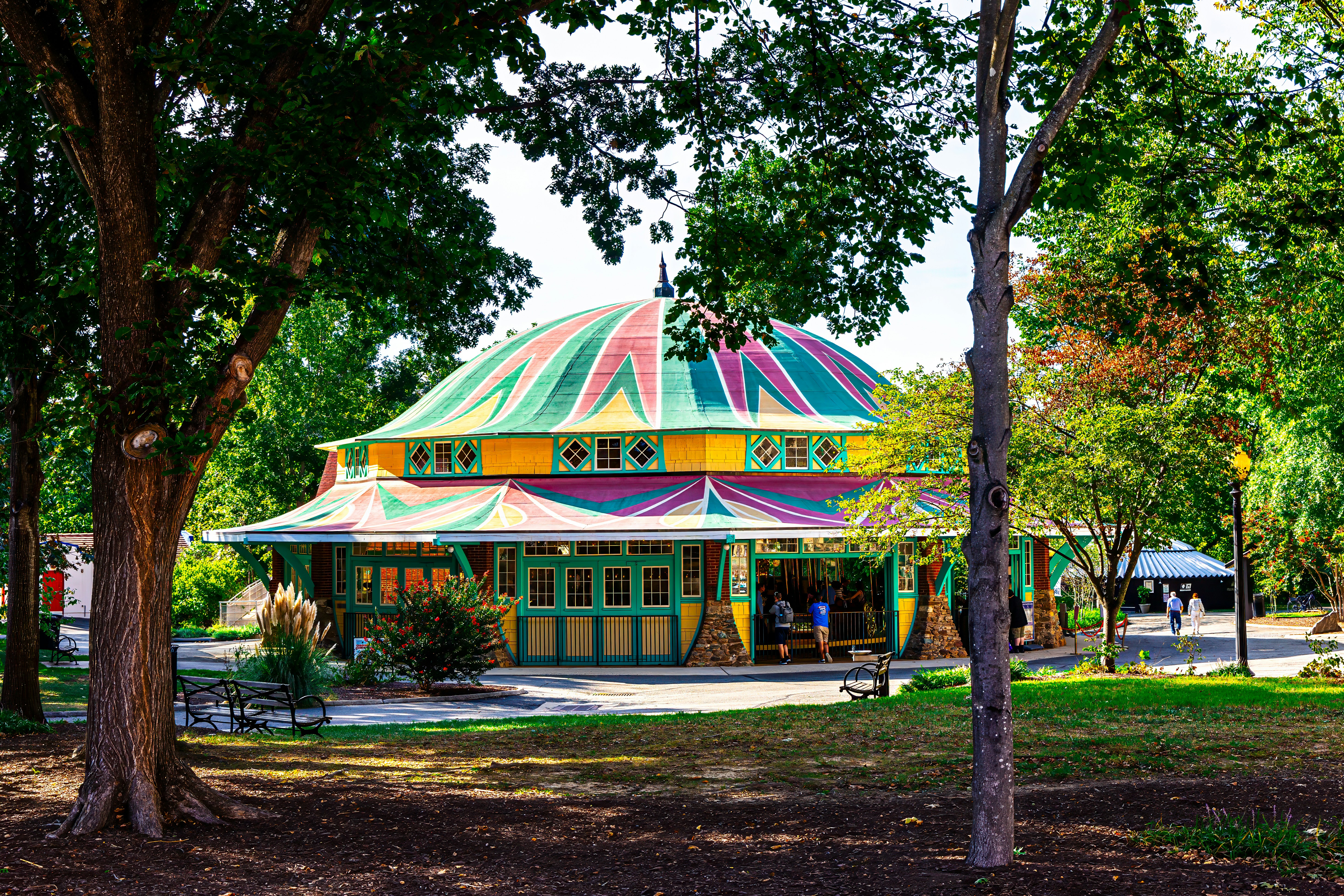 A brightly colored building in the middle of a park