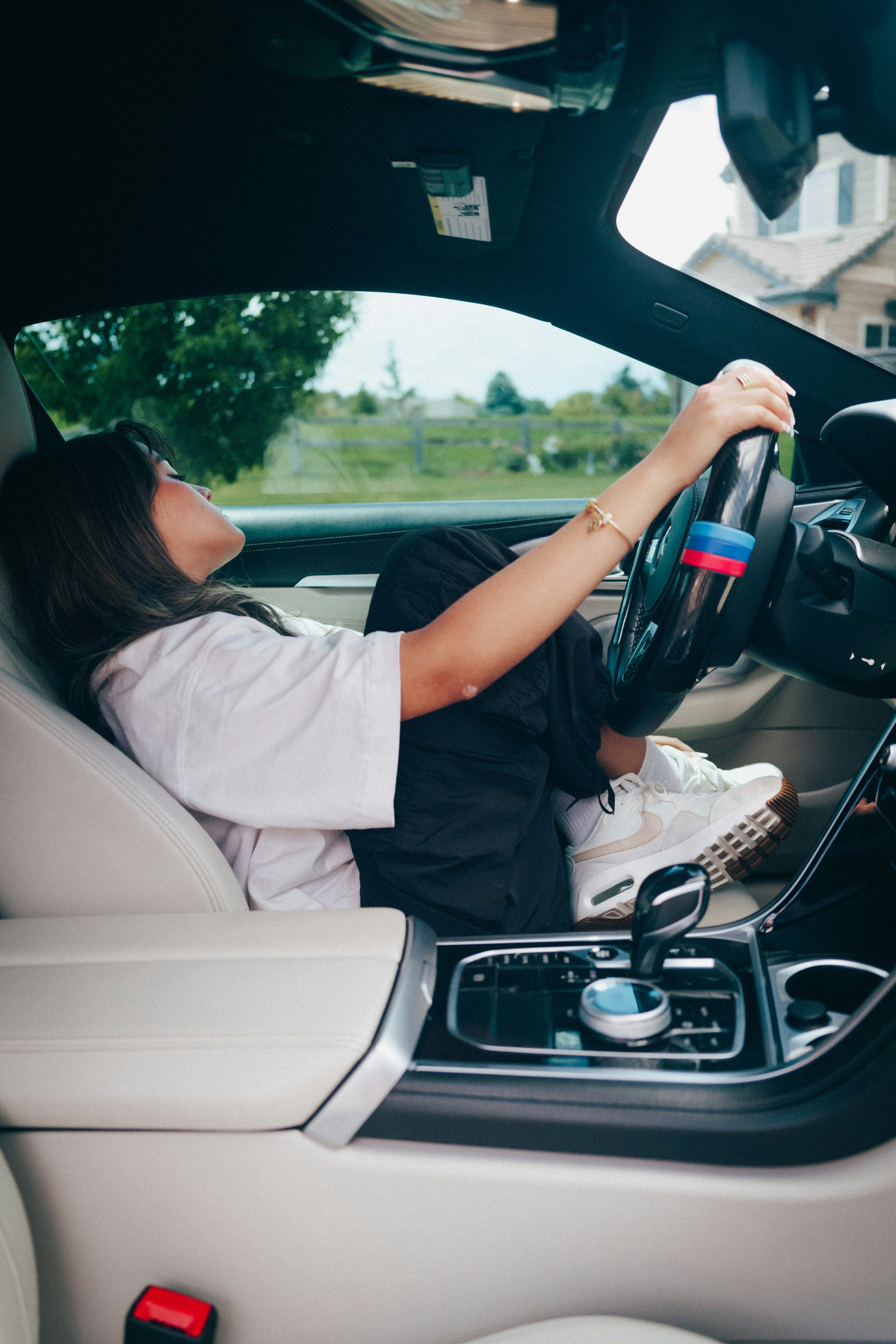 A woman sitting in the driver's seat of a car