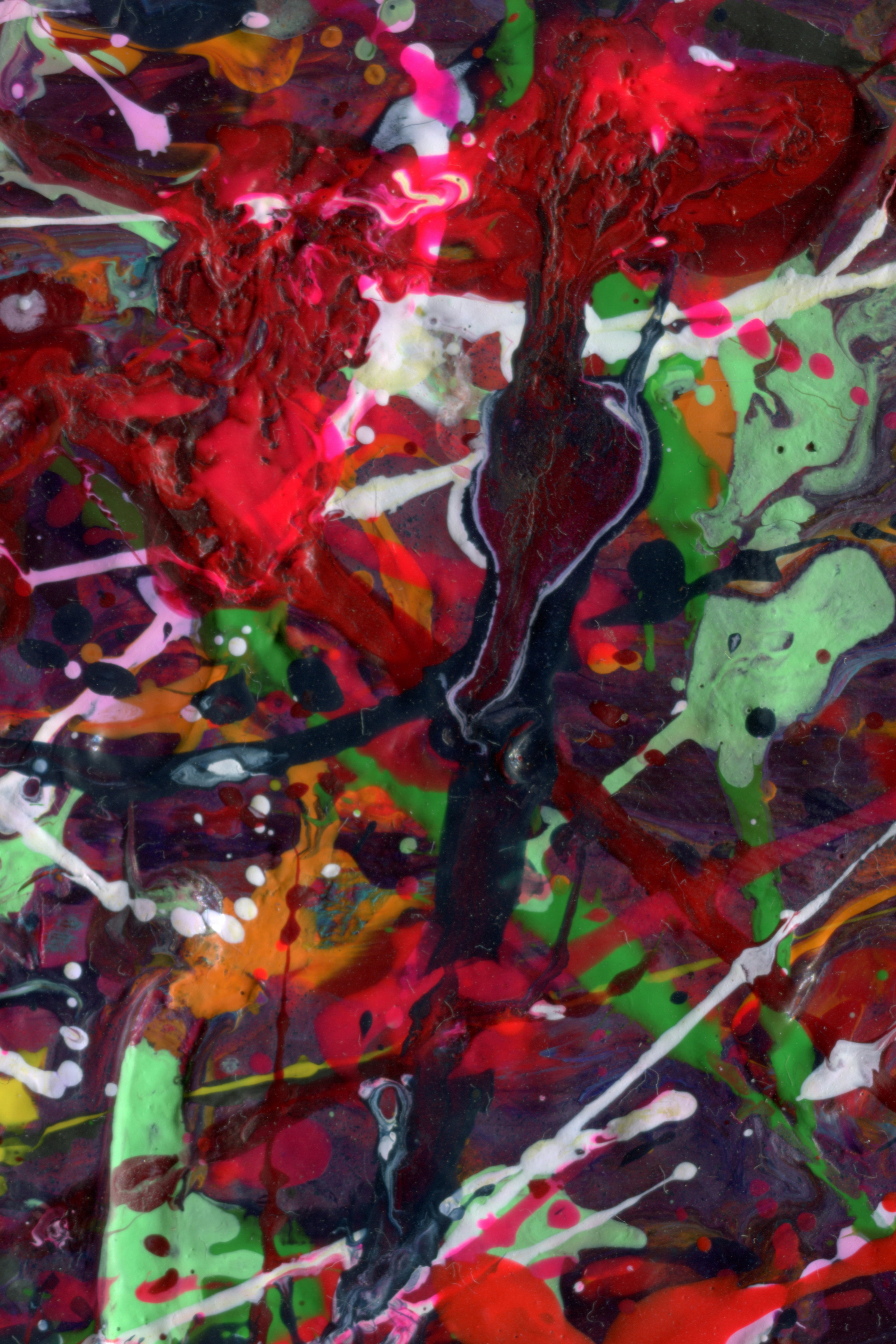 An abstract painting with red, green, and yellow colors