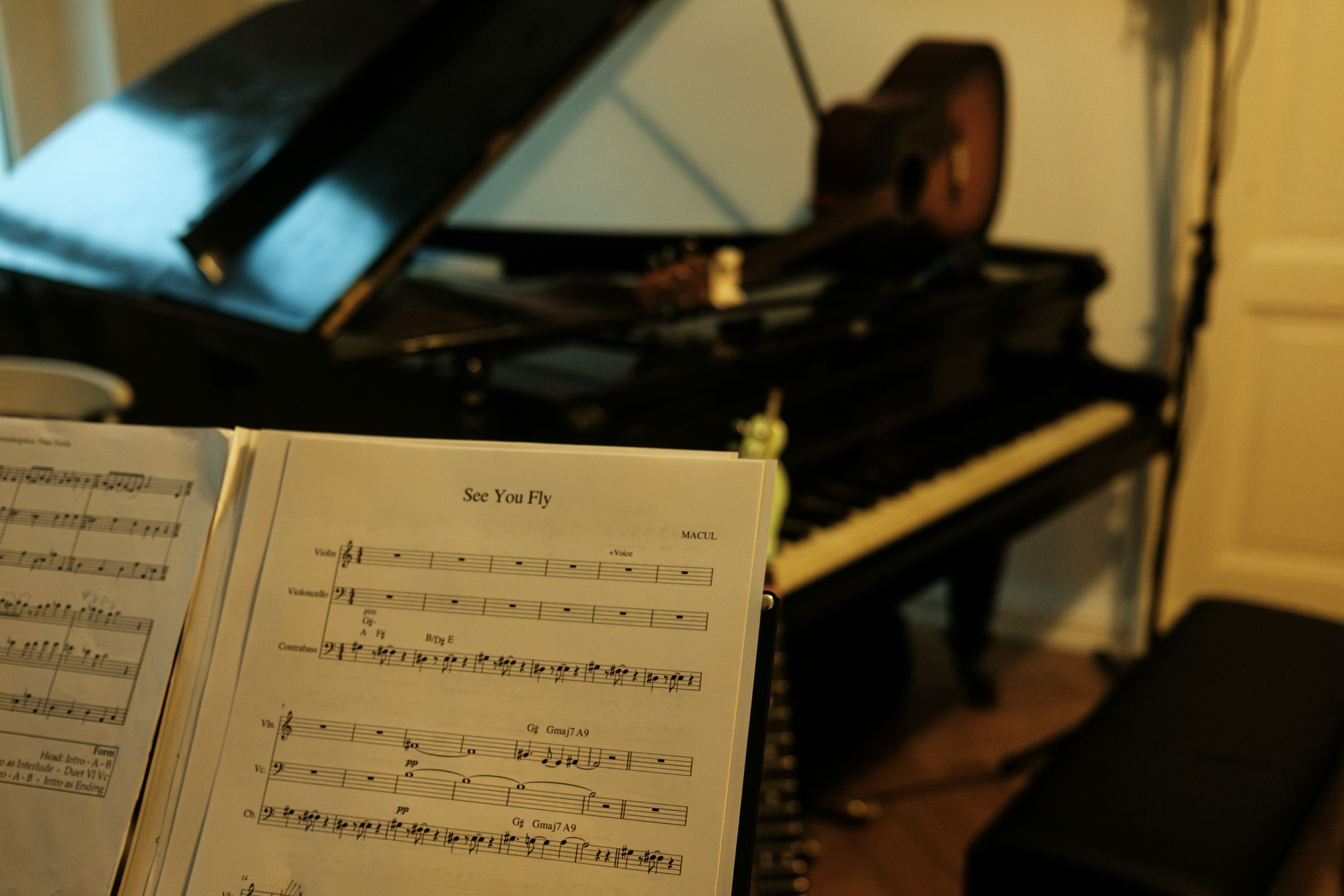 A sheet of music sitting in front of a piano