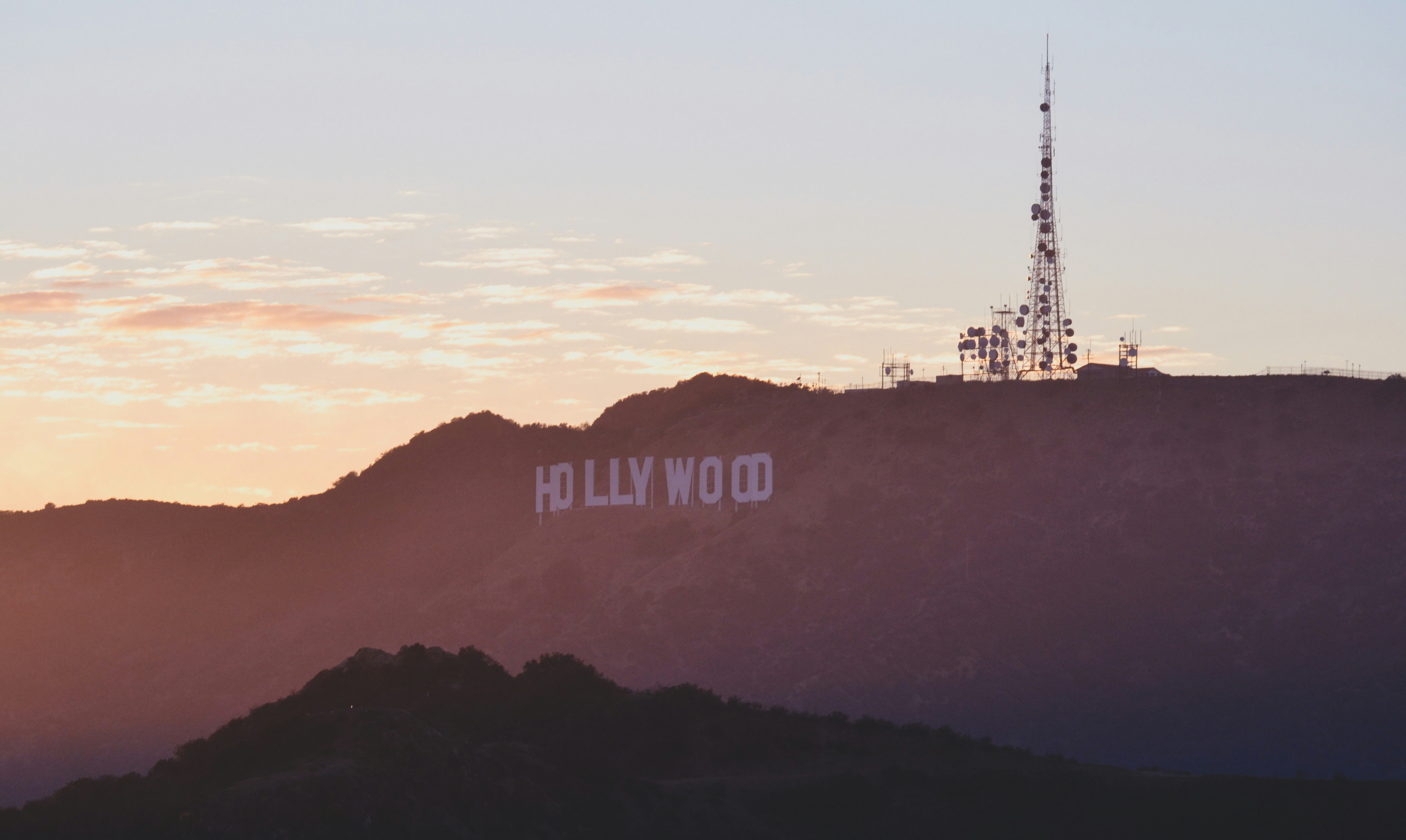 A view of the hollywood sign at sunset