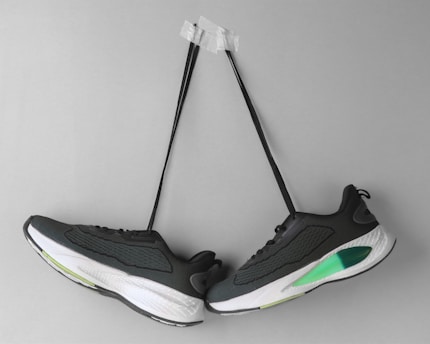 A pair of sneakers hanging on a wall