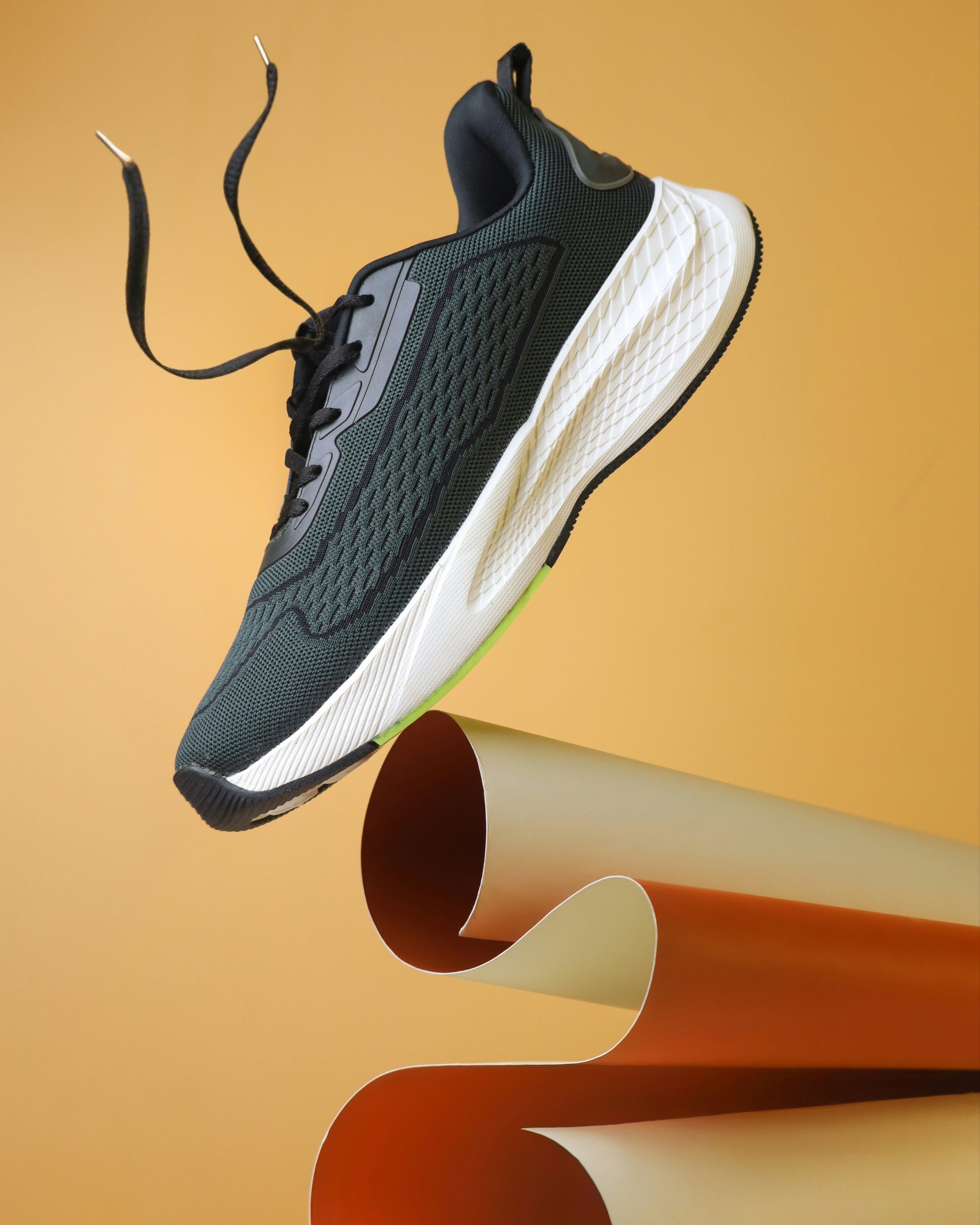 A pair of shoes that are on top of a pole