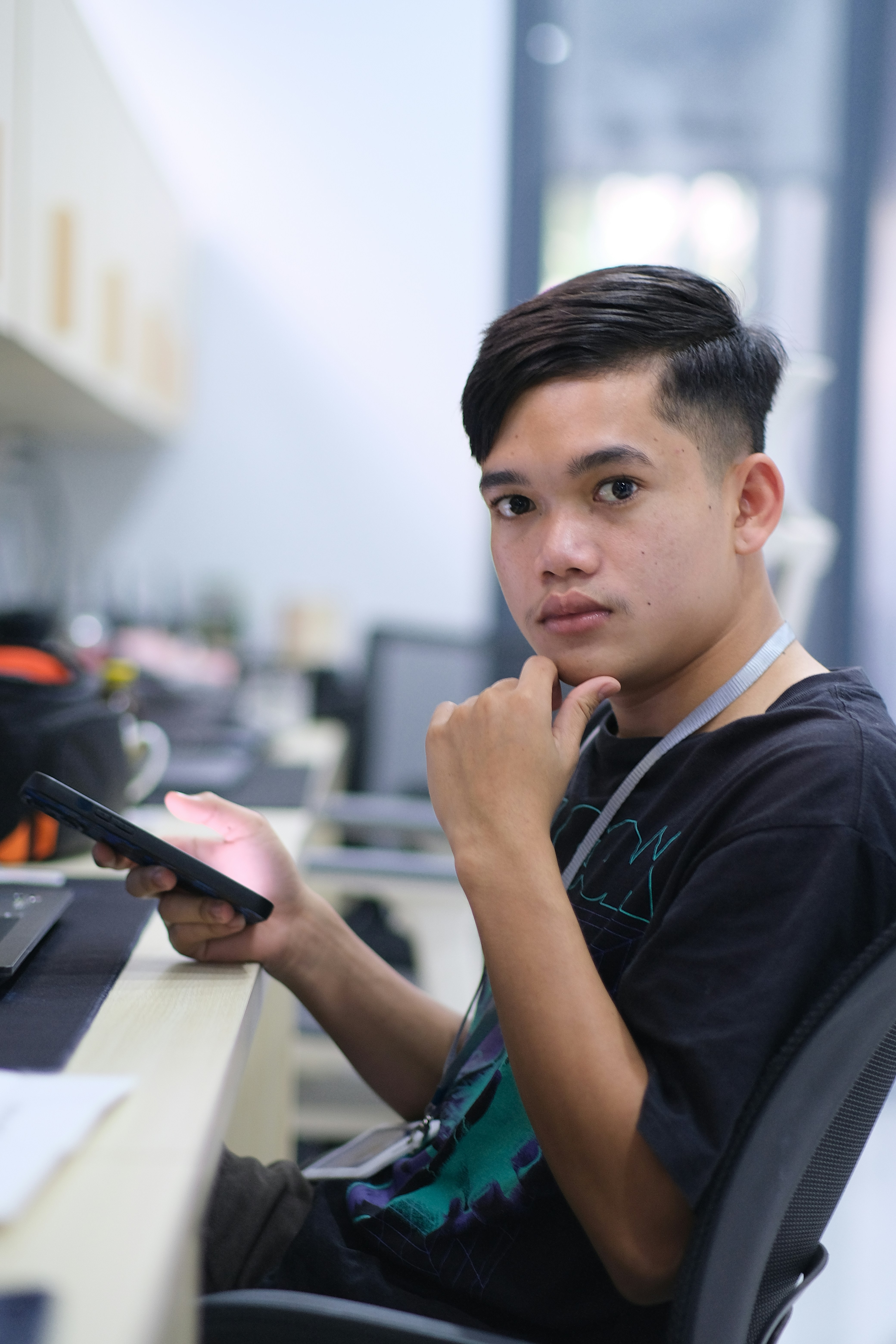 A young man sitting in front of a laptop computer