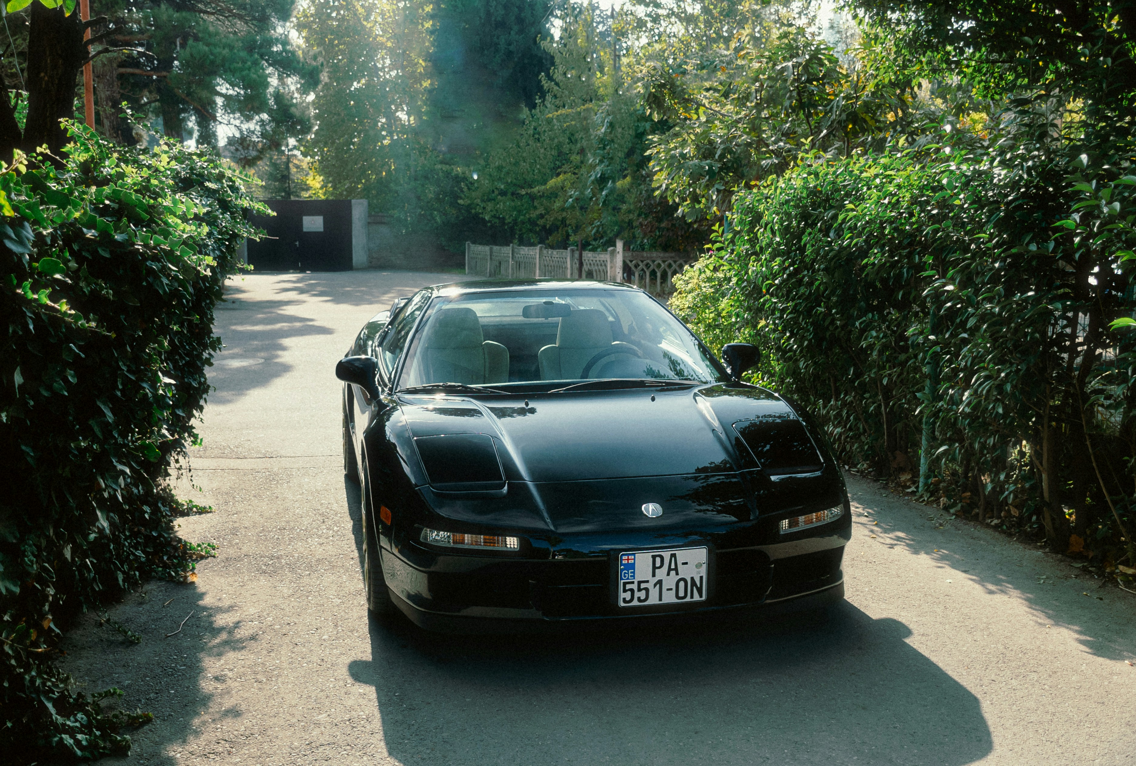 A black sports car parked on the side of a road