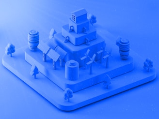 A blue model of a building with a clock on top of it