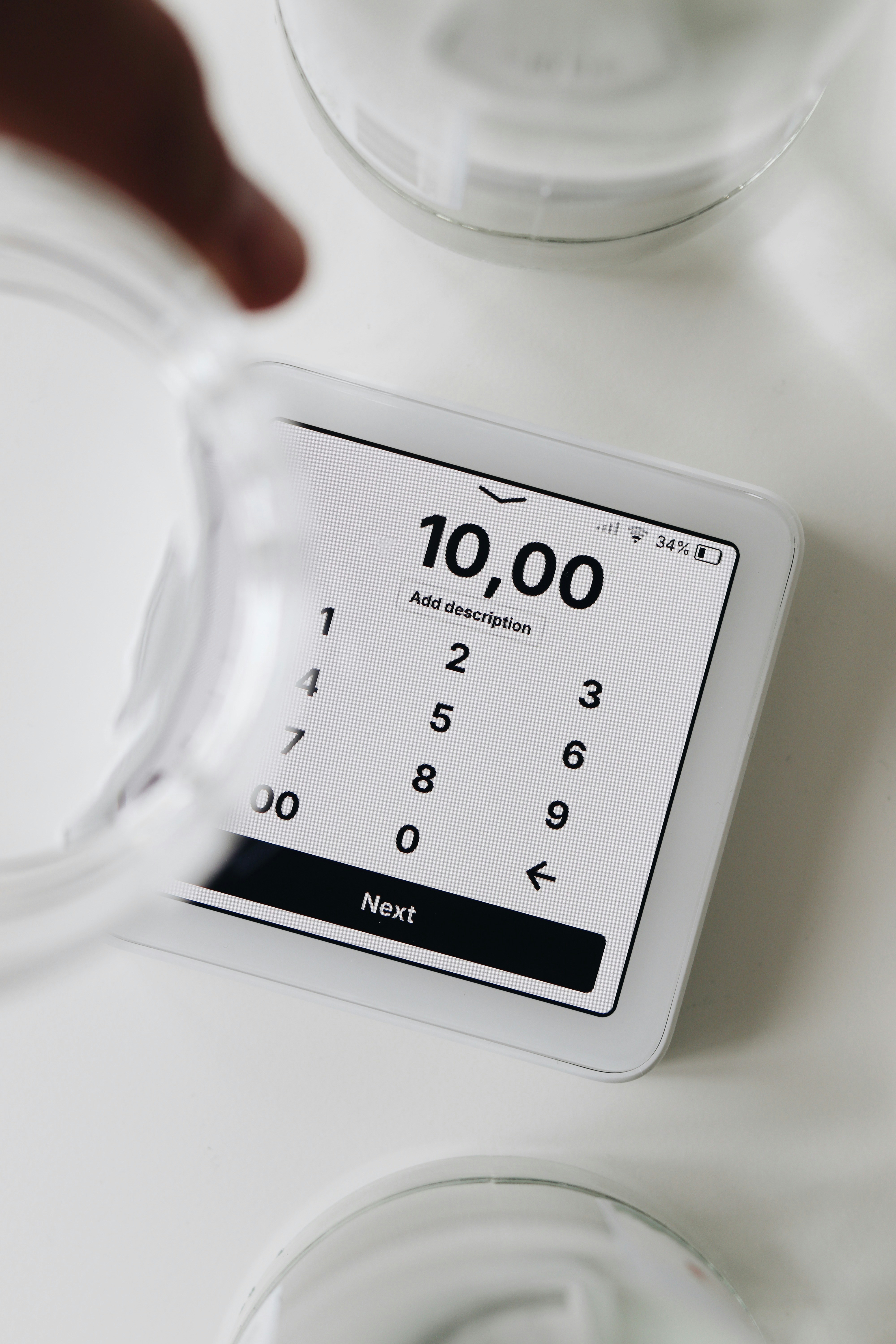 A person holding a glass with a clock on it