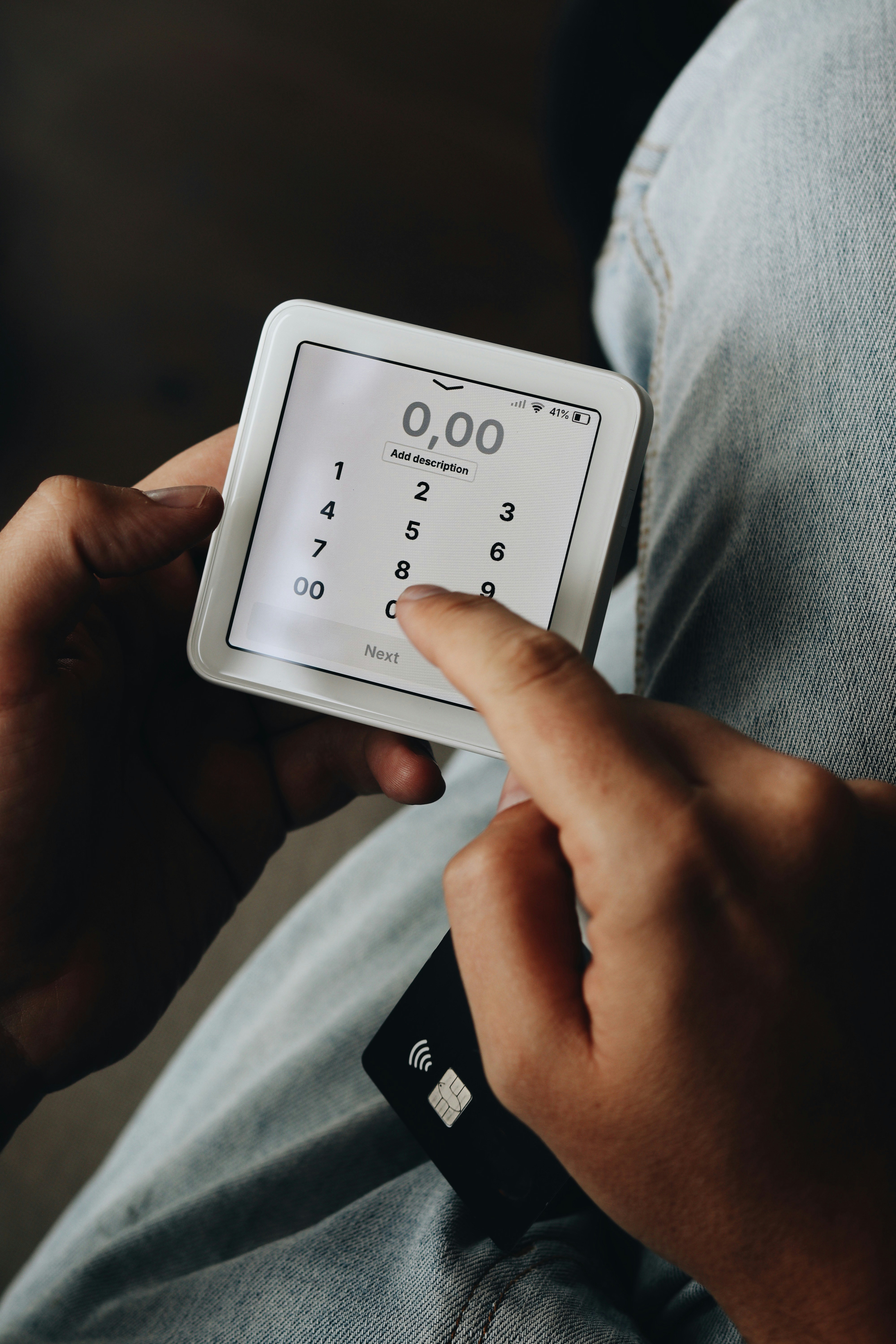 A person sitting on a couch holding a smart device