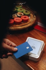 A person holding a credit card in their hand