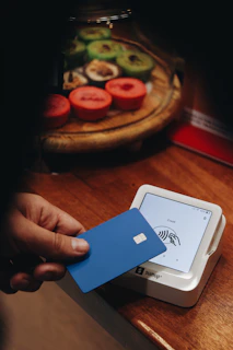 A person holding a credit card in their hand