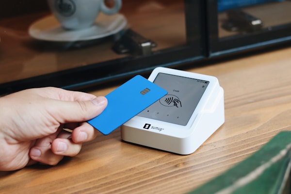 A person holding a blue card in their hand