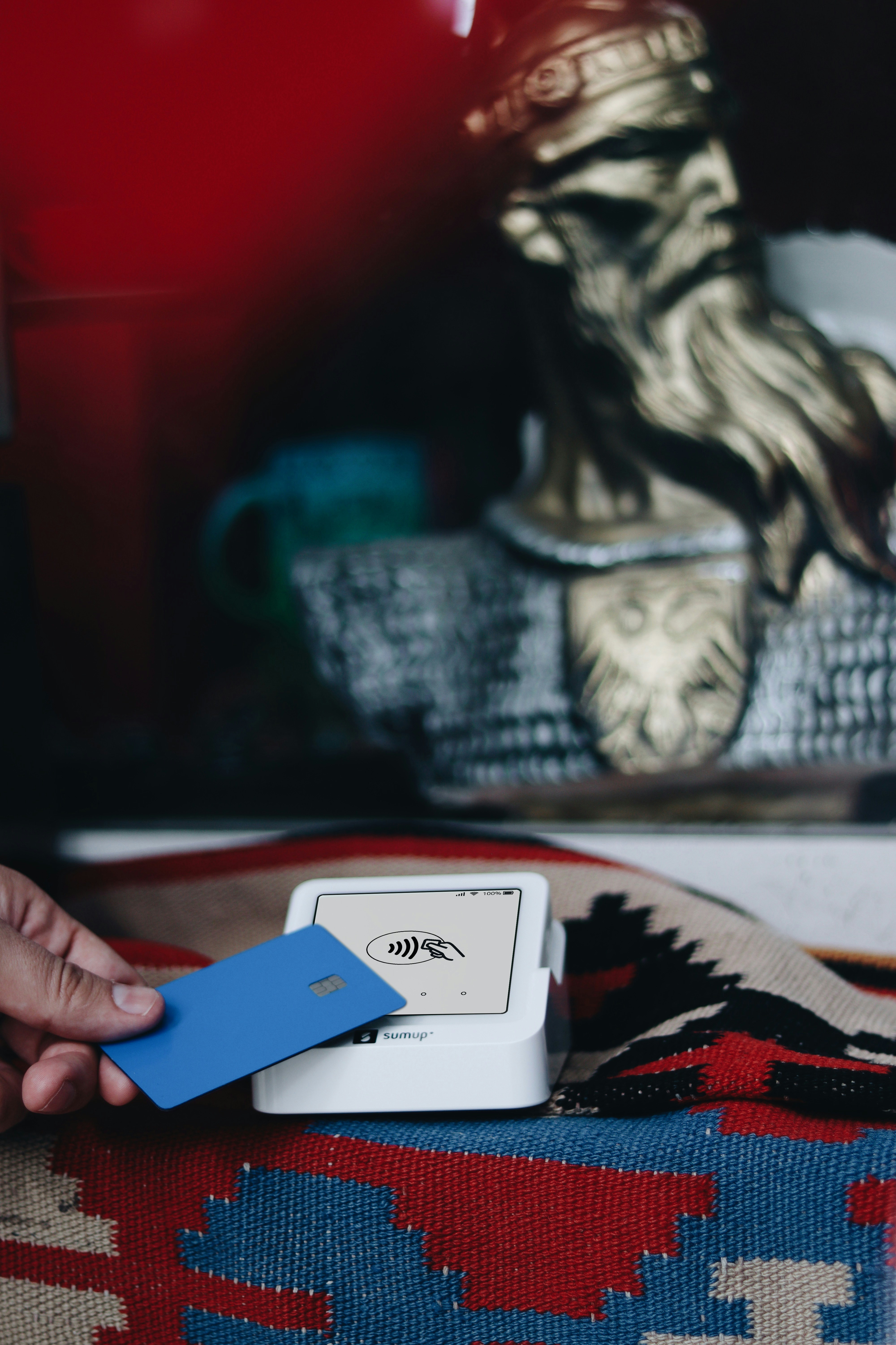 A person holding a blue card in their hand