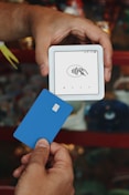 A person holding a credit card in their hand
