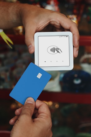 A person holding a credit card in their hand