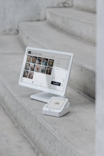 A computer monitor sitting on top of a set of stairs