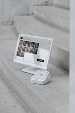 A computer monitor sitting on top of a set of stairs