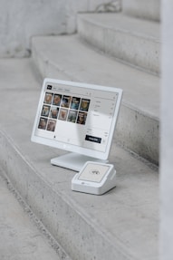 A computer monitor sitting on top of a set of stairs