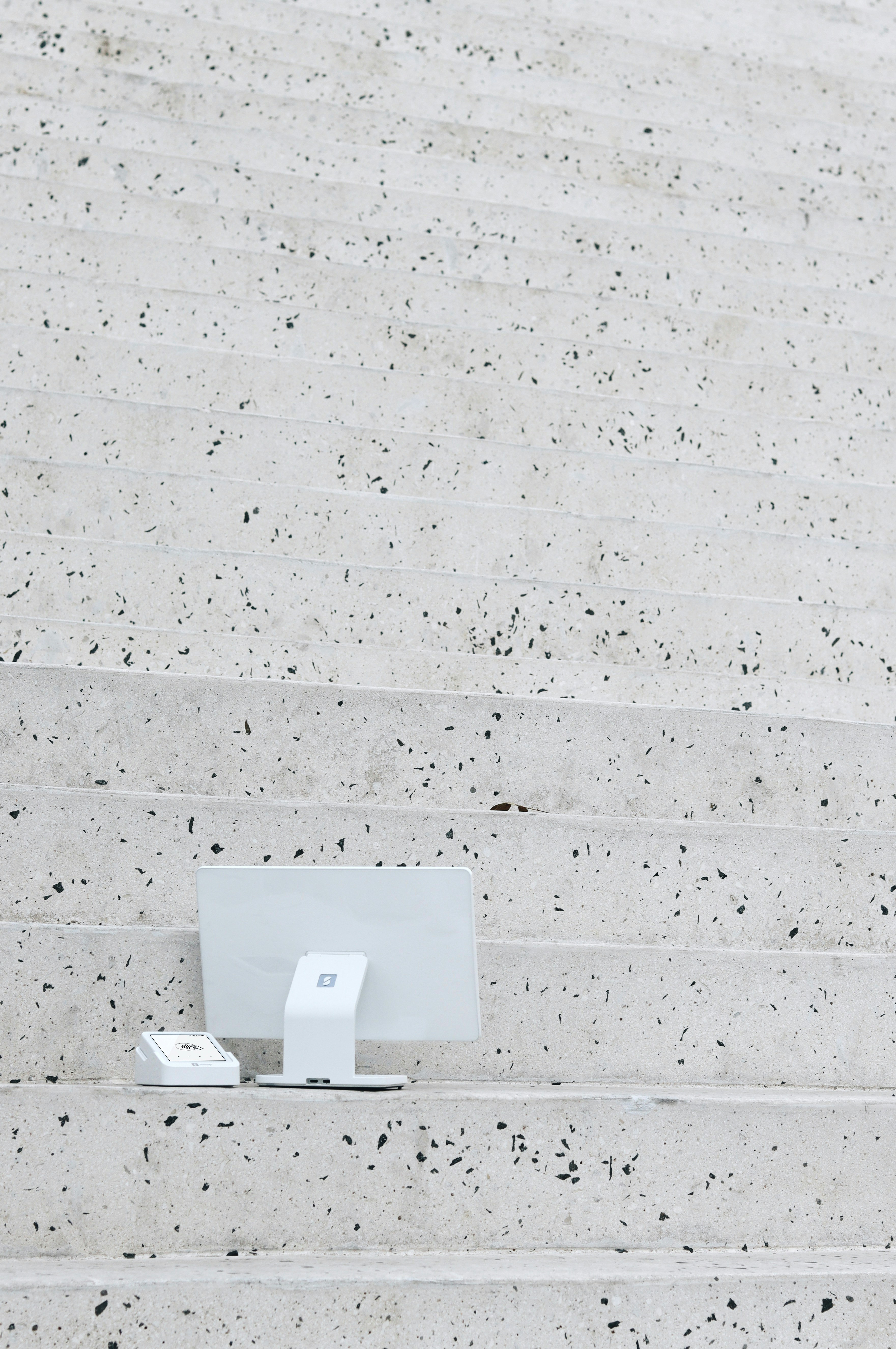 A laptop computer sitting on top of a set of steps