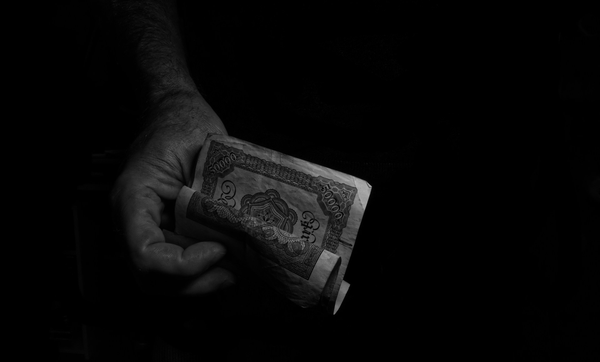 A person holding a piece of paper in their hand