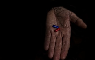 A person holding a pill pill in their hand