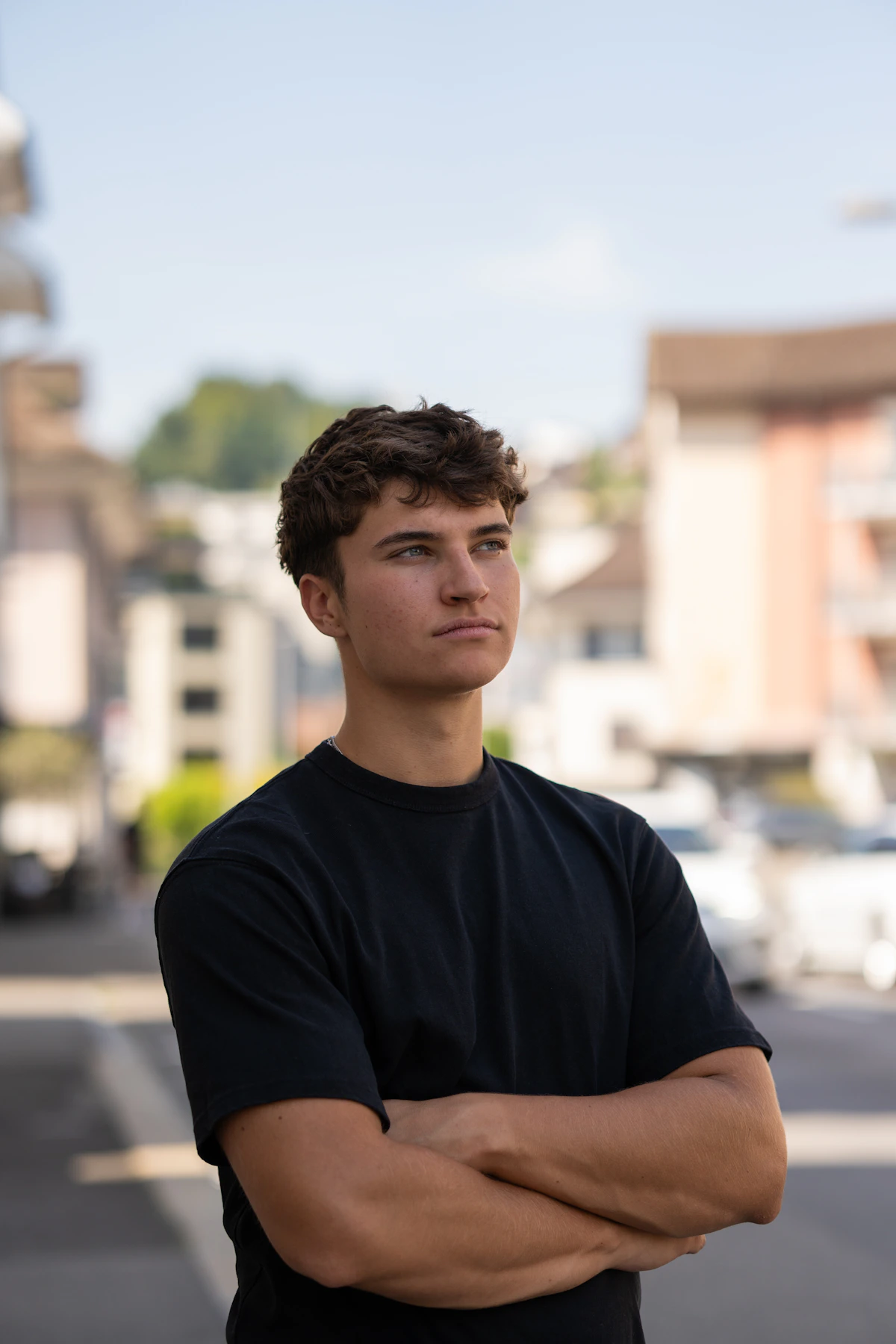 A young man looking off to the side, thoughtful and steady