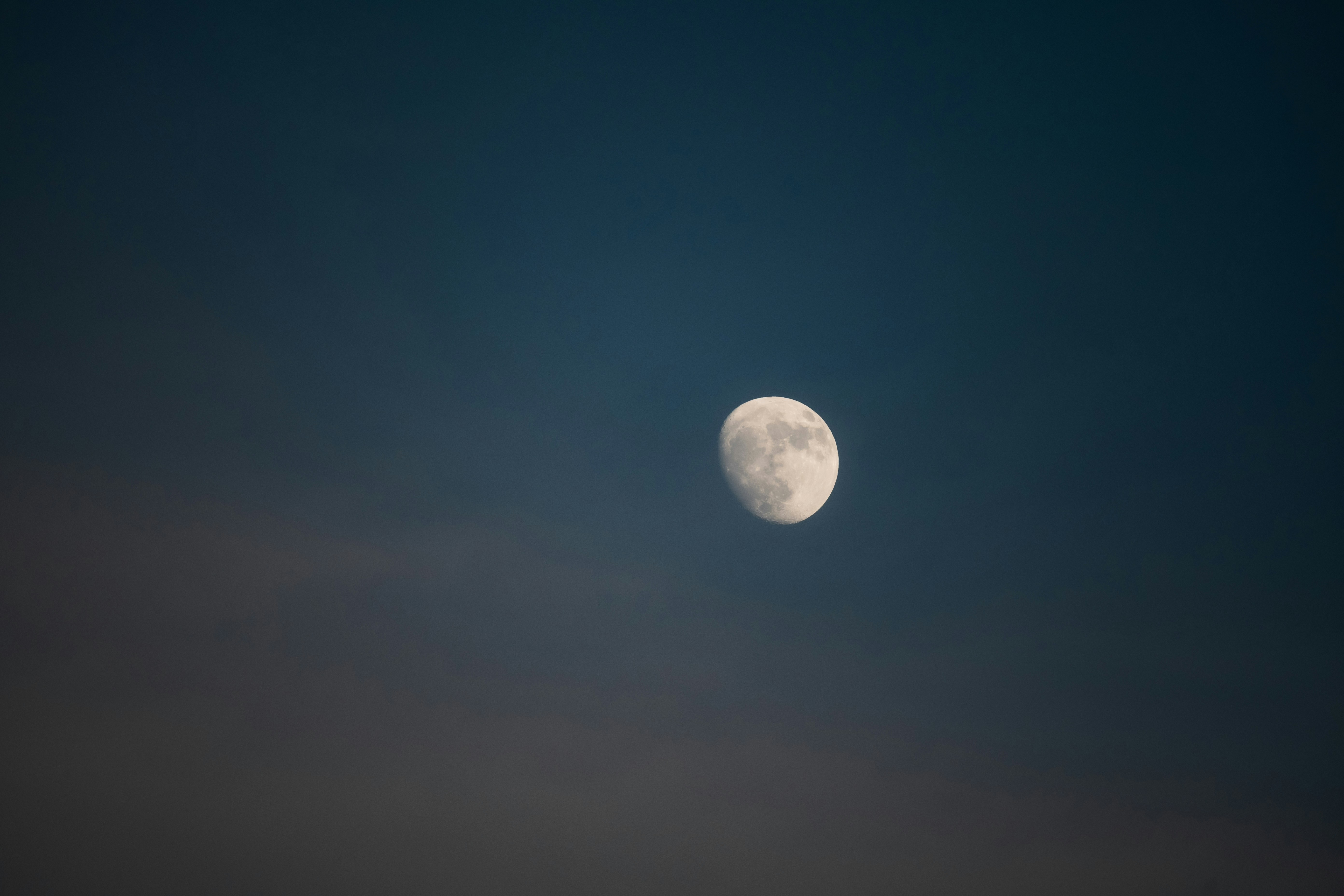 A full moon is seen in the night sky