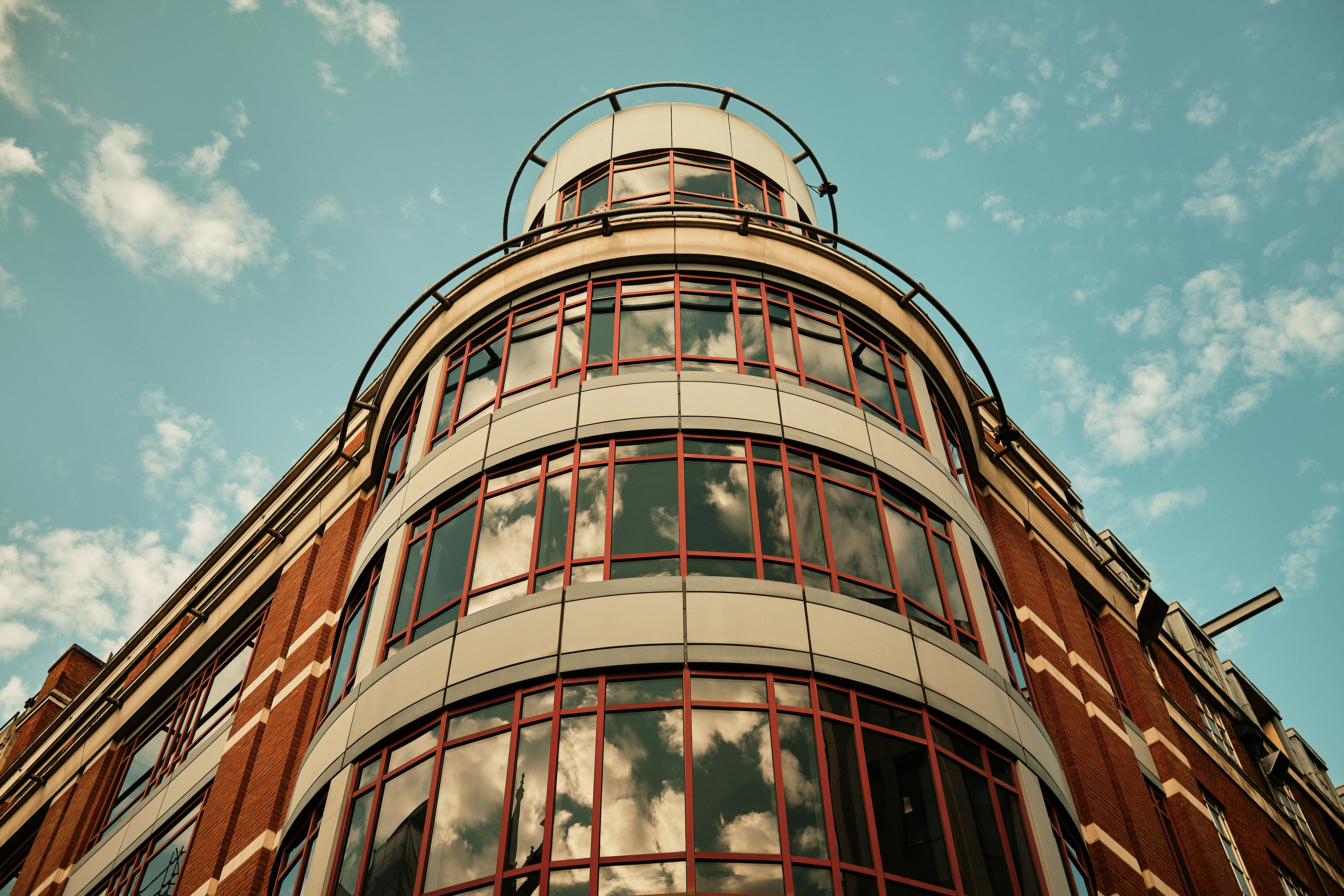 A tall building with lots of windows and a sky background