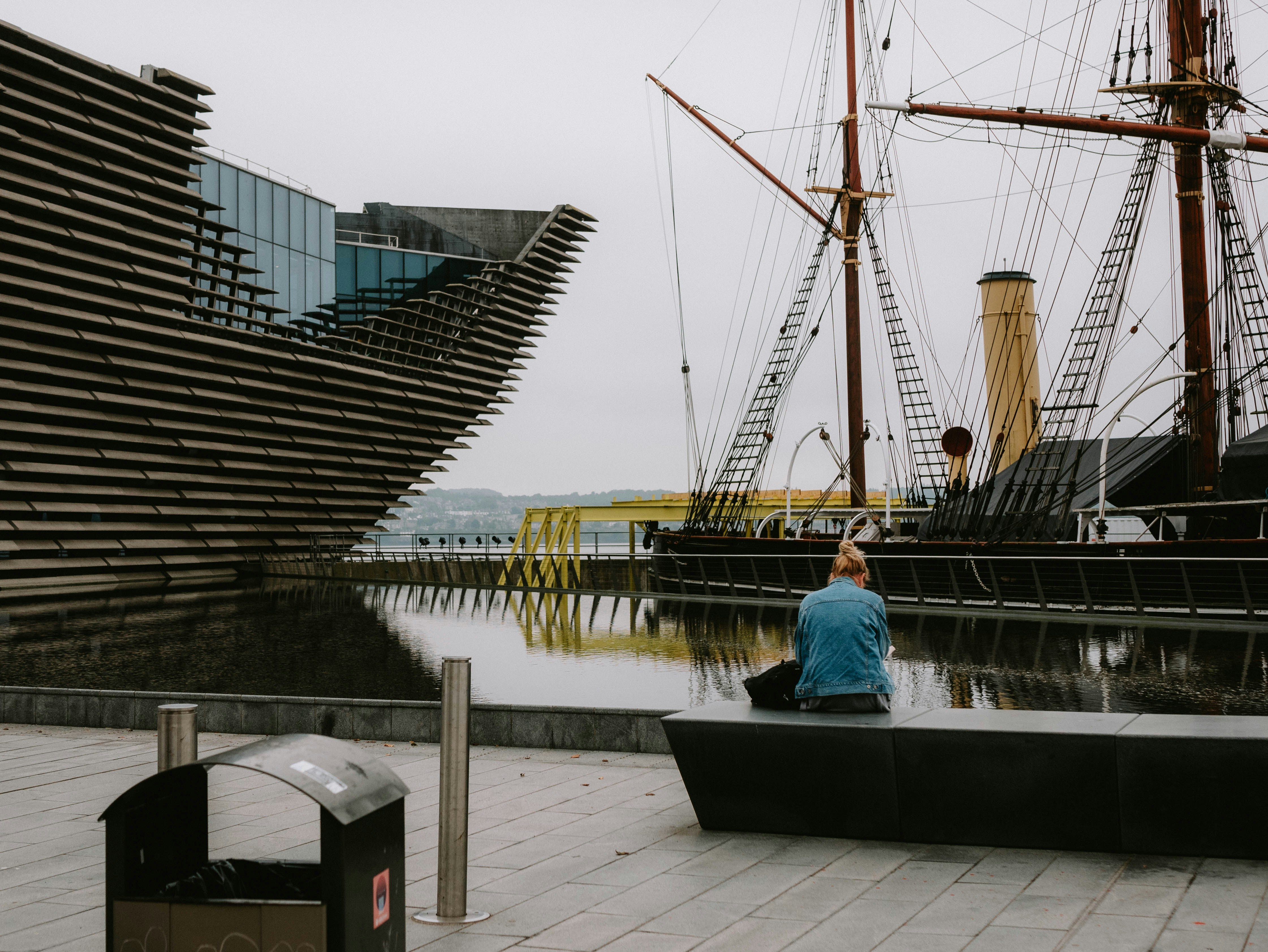 A man is sitting on a boat in the water