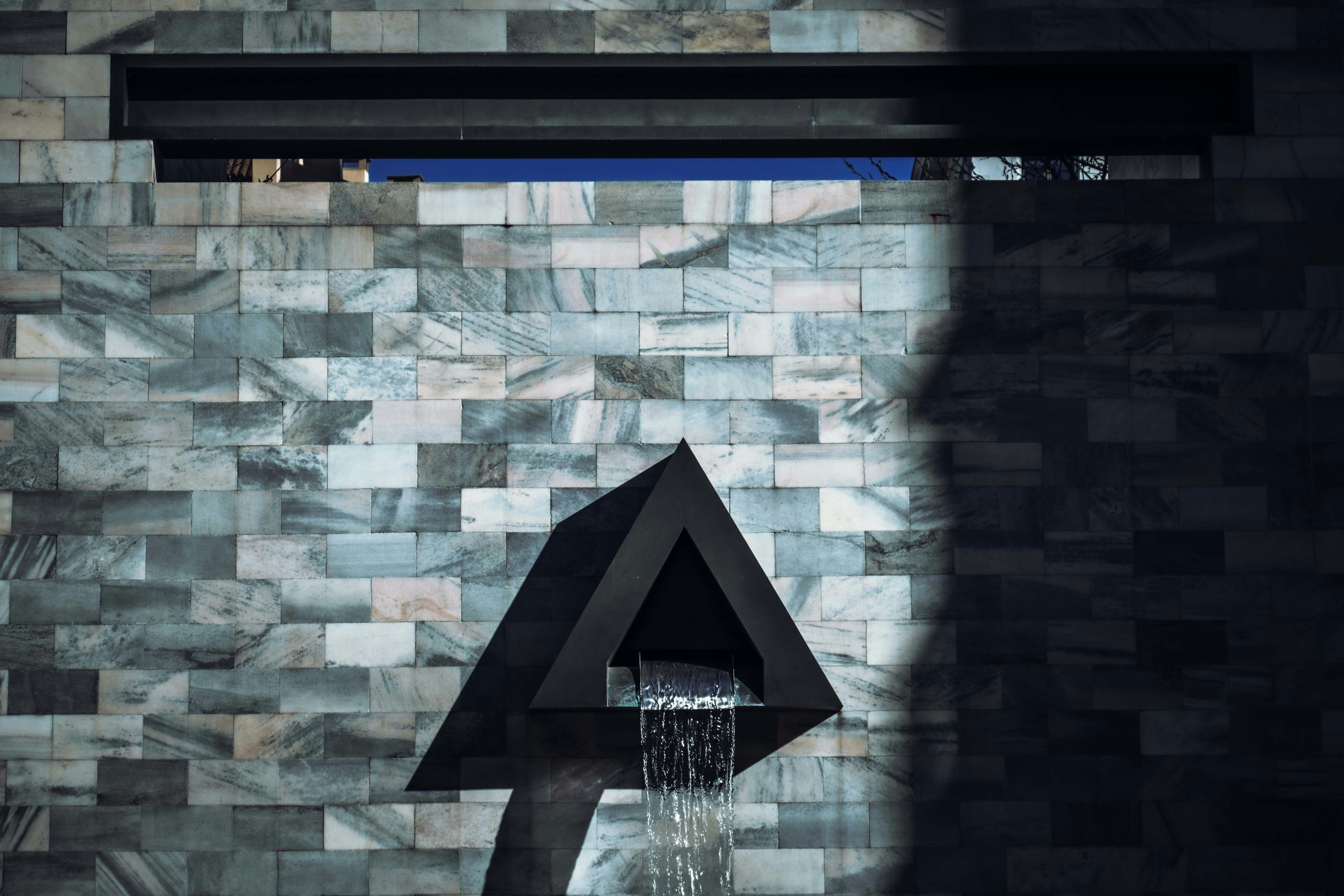 Water fountain cascading over natural stone in warm evening light
