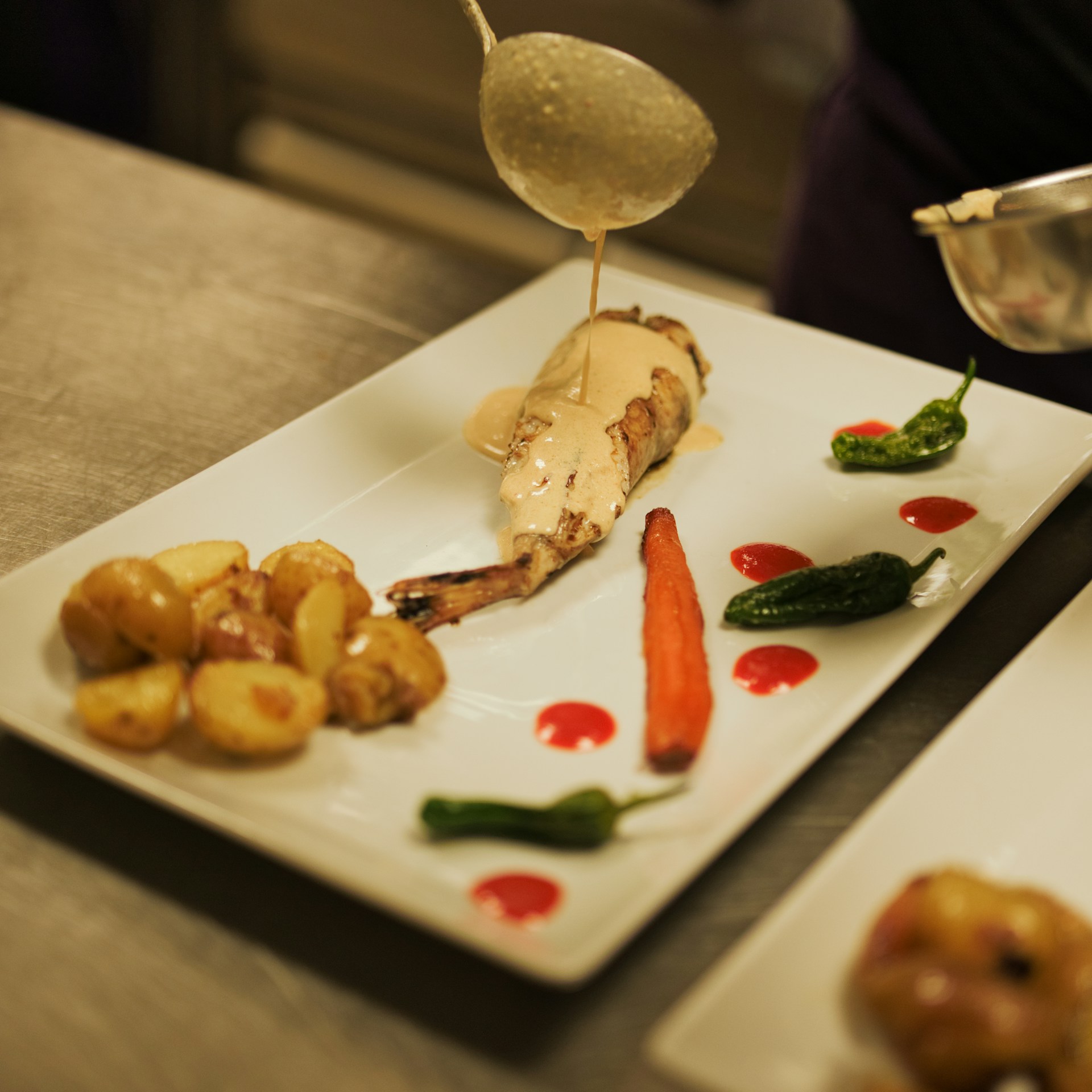 A plate of food on a table with a spoon