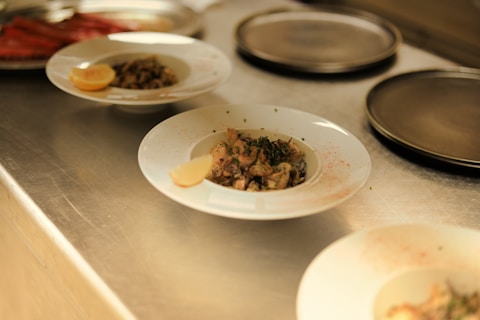 Several plates of food sitting on a counter