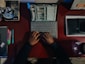 A person sitting at a desk with a laptop