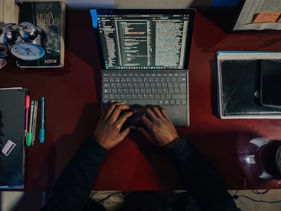 A person sitting at a desk with a laptop