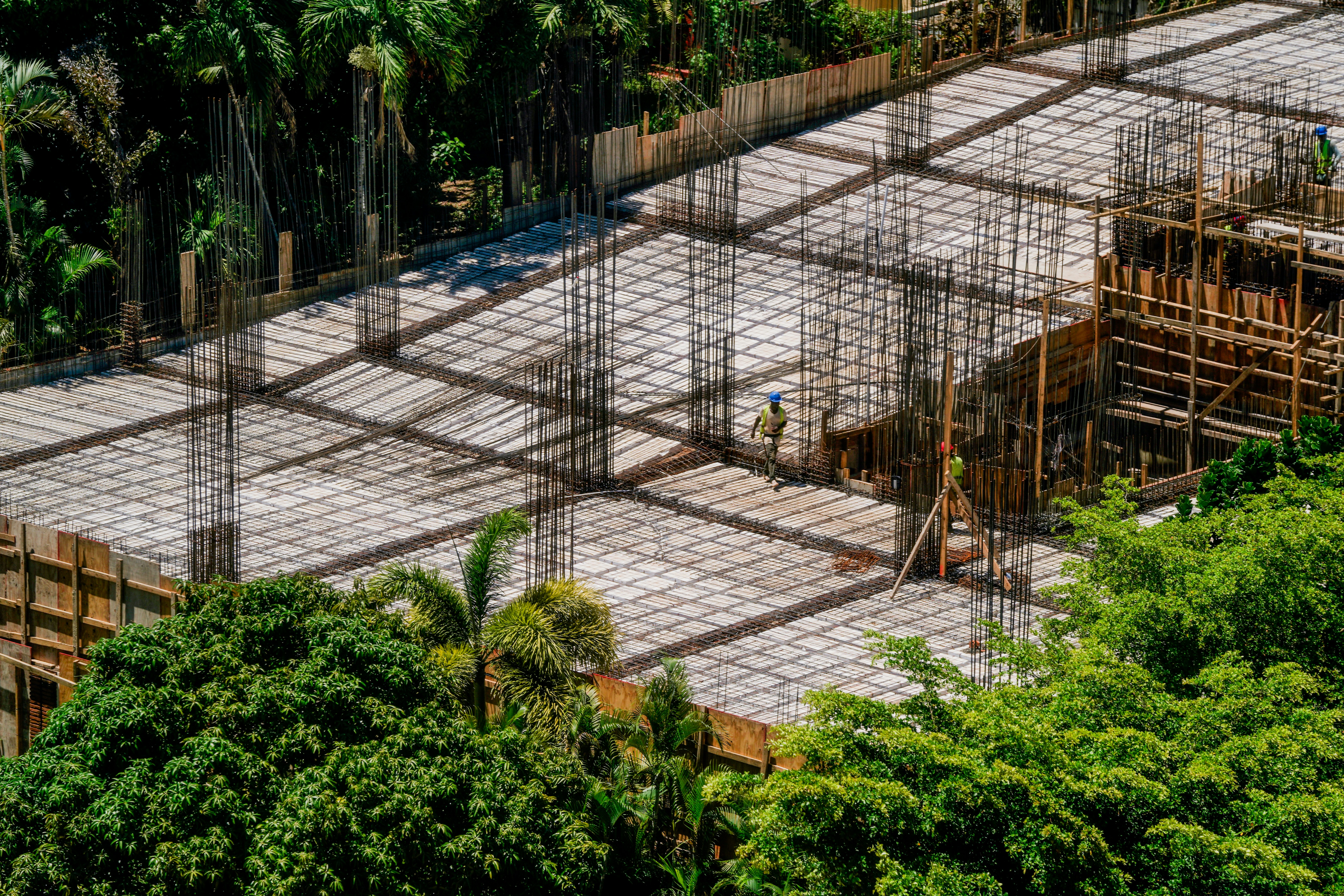 A construction site with scaffolding and trees in the background