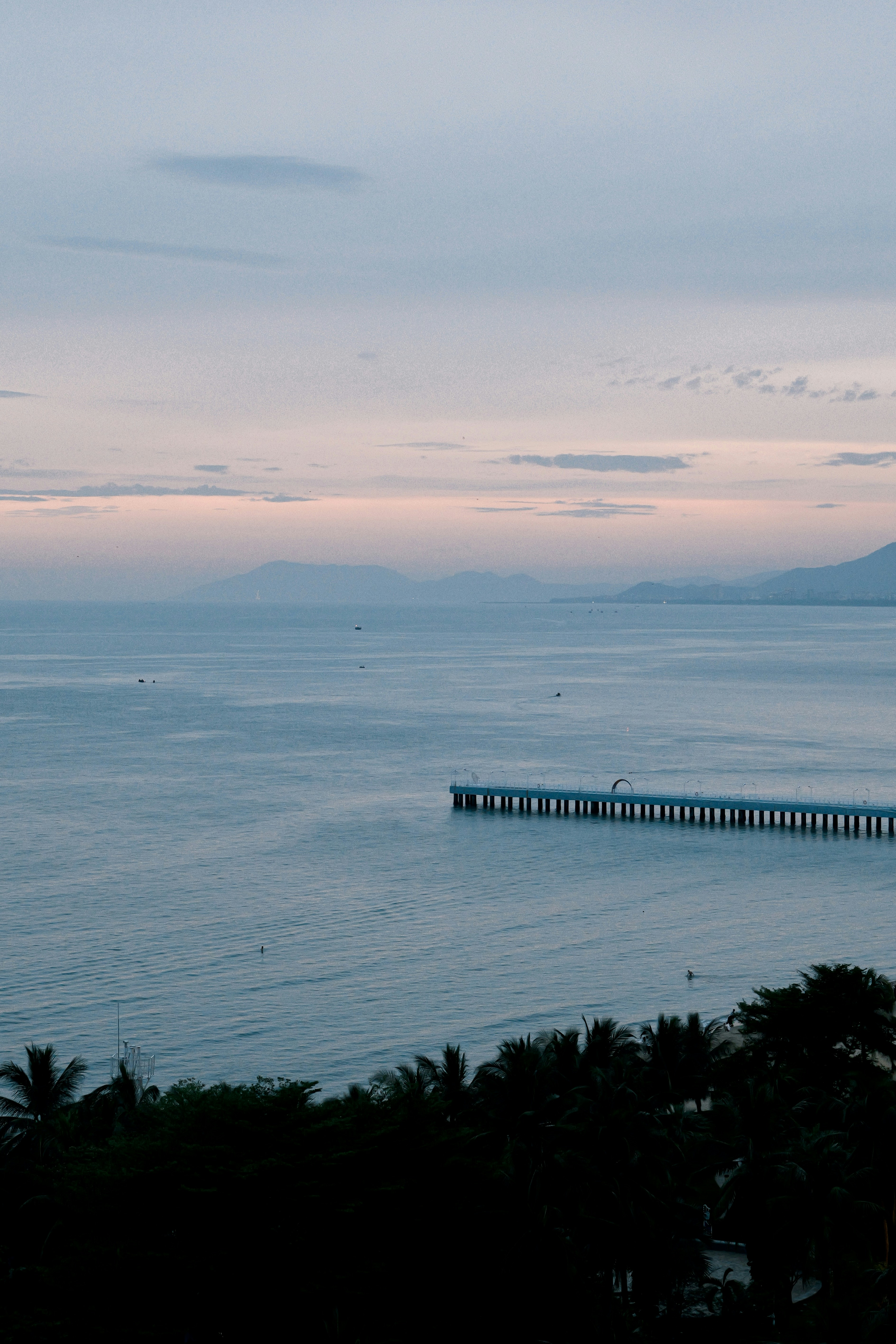 A view of a body of water with a pier in the distance