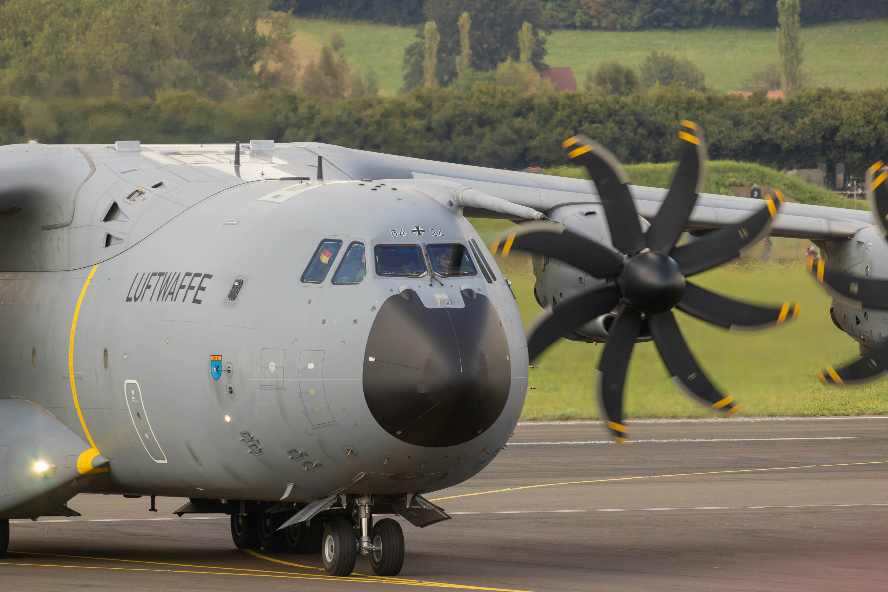 A large propeller plane sitting on top of an airport runway