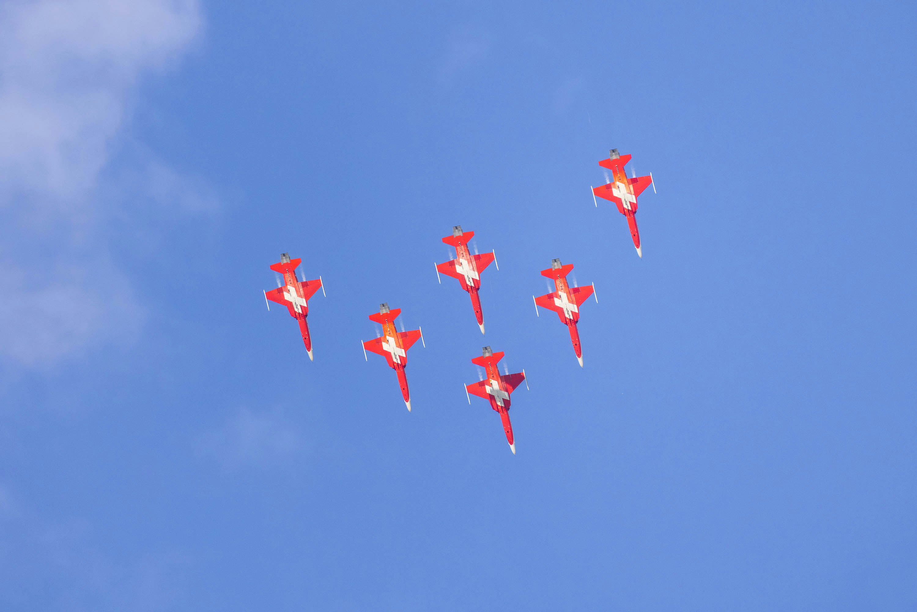 A group of planes flying in formation in the sky