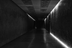 A long hallway with a light at the end of it