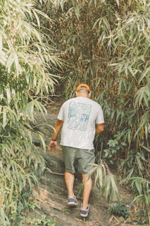 A man walking up a trail in the woods