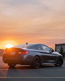A car driving down the road at sunset