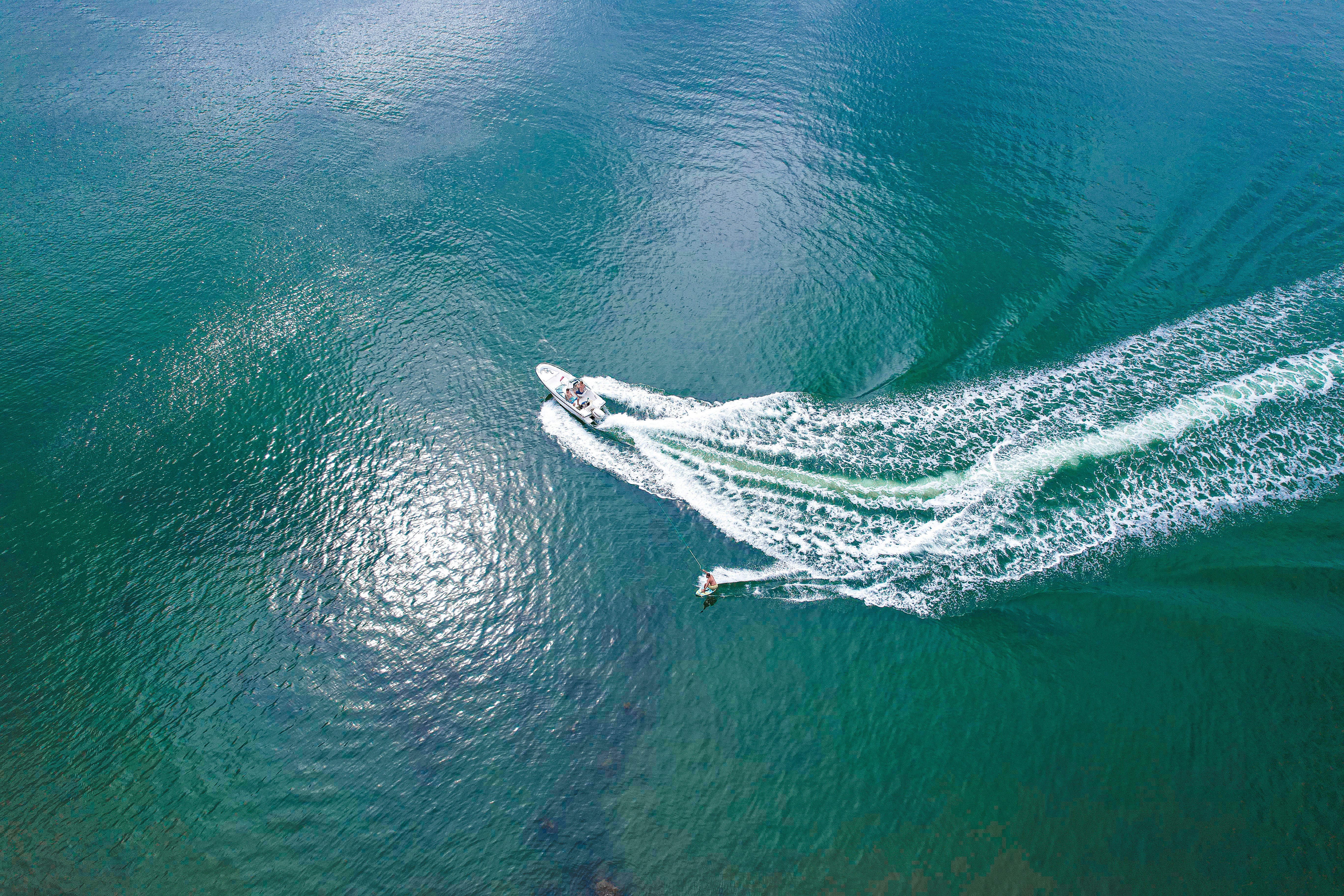 A group of people riding jet skis on top of a body of water