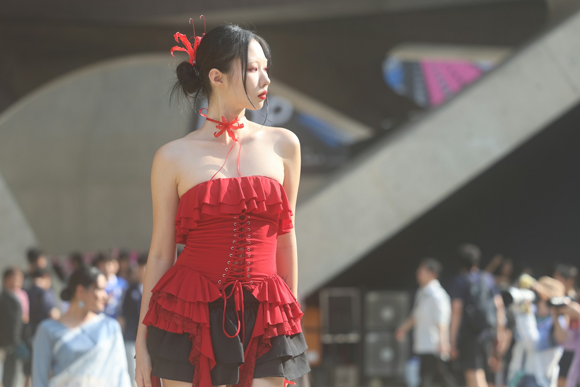 A woman in a red top and black skirt