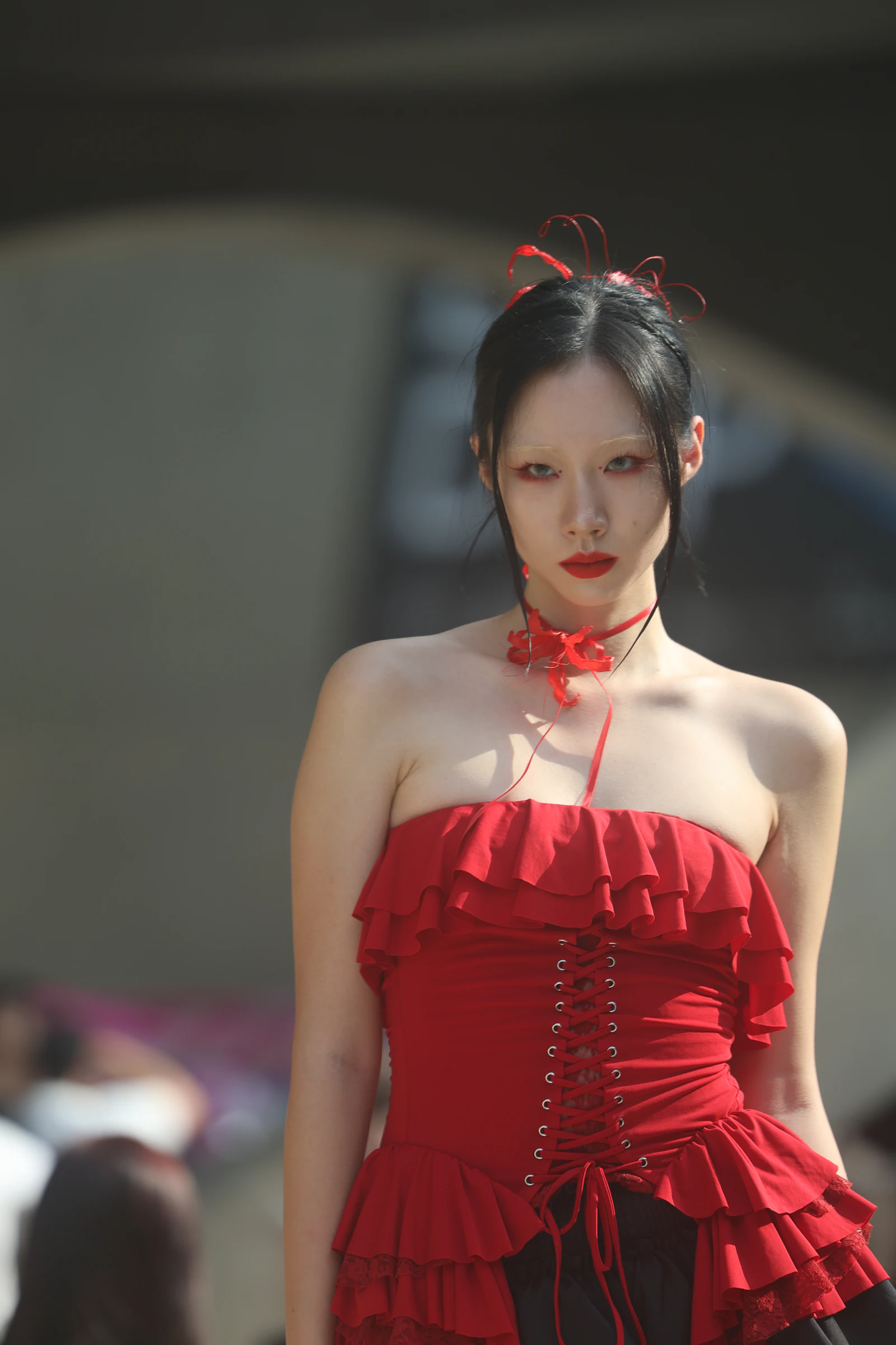 Model in a red dress photographed in Seoul