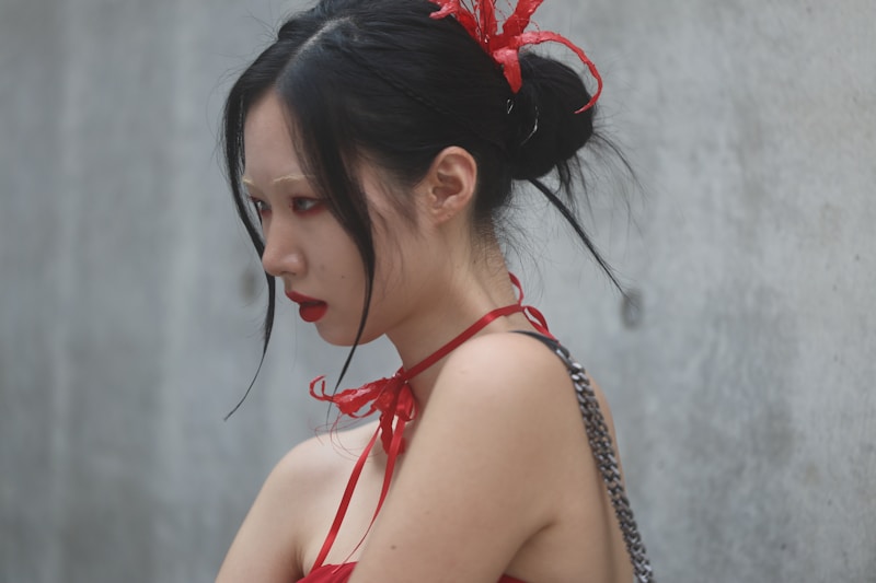 A woman in a red dress holding a cell phone