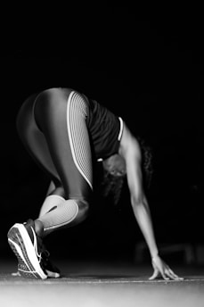 A black and white photo of a woman doing a handstand