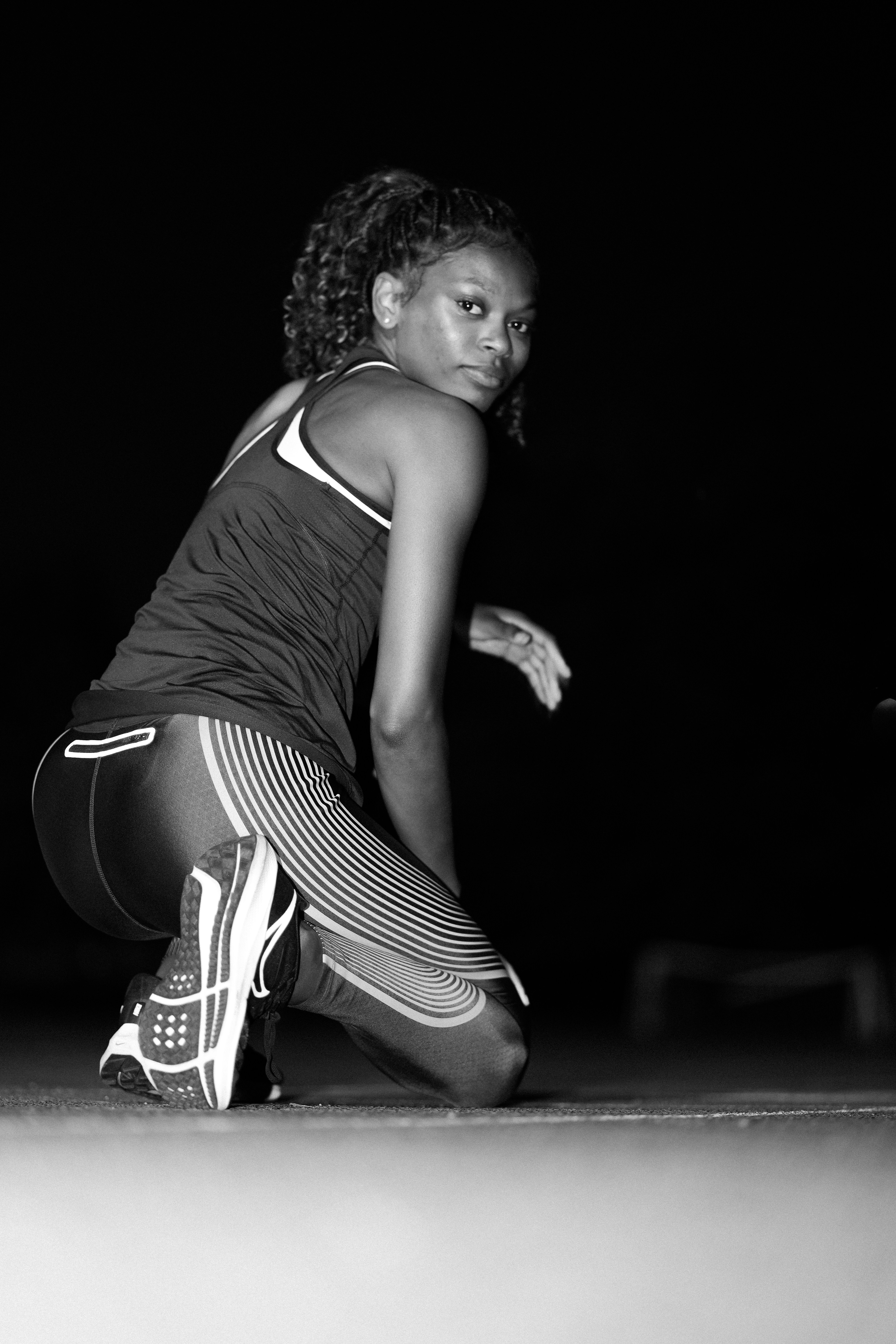 A black and white photo of a woman playing tennis